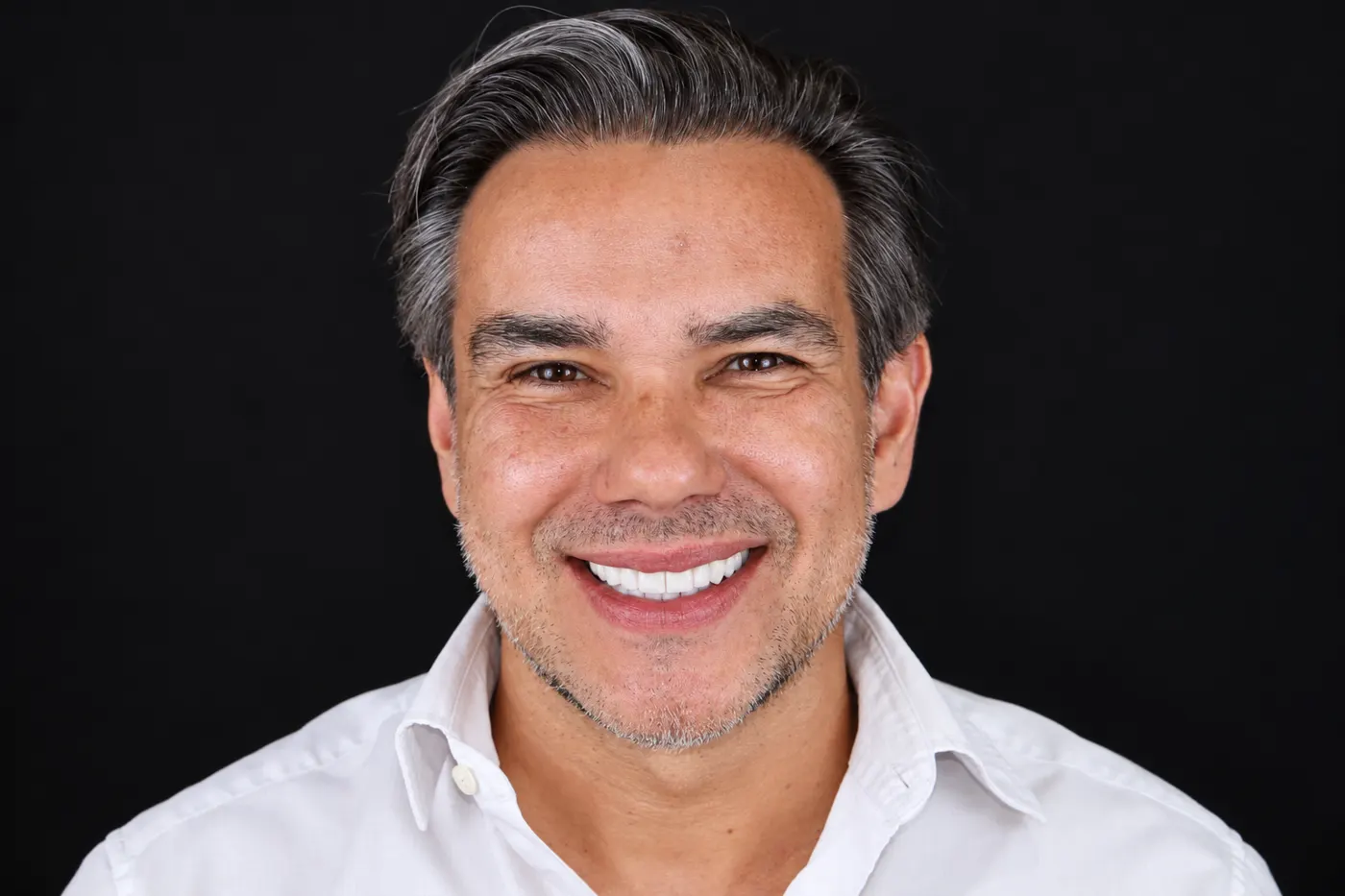 Patient smiling after full ceramic veneers